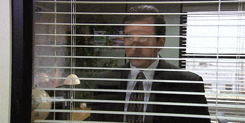 Michael Scott looking out over his employees in The Office