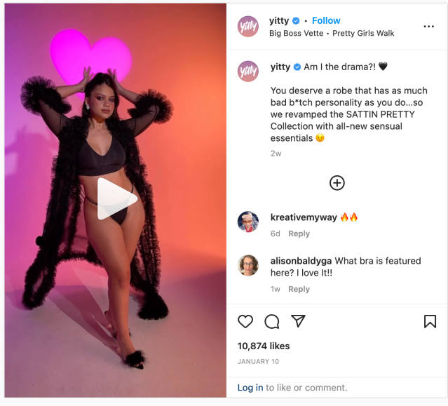 Screenshot of a Yitty Instagram Reel featuring a model of color in a sheer robe and Yitty lingerie. Caption: "Am I the drama?! You deserve a robe that has as much bad b*tch personality as you do...so we ravamped the SATTIN PRETTY Collection with all-new sensual essentials"