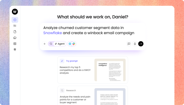 A close-up view of WRITER Agent with a light background. At the top, a heading reads "What should we work on, Daniel?" Below this is a prominent text input box containing the prompt: "Analyze churned customer segment data in Snowflake and create a winback email campaign." The input box includes icons for adding attachments, selecting an agent, and integrations like Snowflake and Slack. Below the input box, there are suggested prompt cards stacked vertically. The top card is labeled "Try prompt" and suggests "Research my top 5 competitors and do a SWOT analysis," accompanied by a document preview. The second card is labeled "Research" and suggests "Analyze the needs and pain points for a customer or buyer segment." A sidebar menu with icons is visible on the left edge.